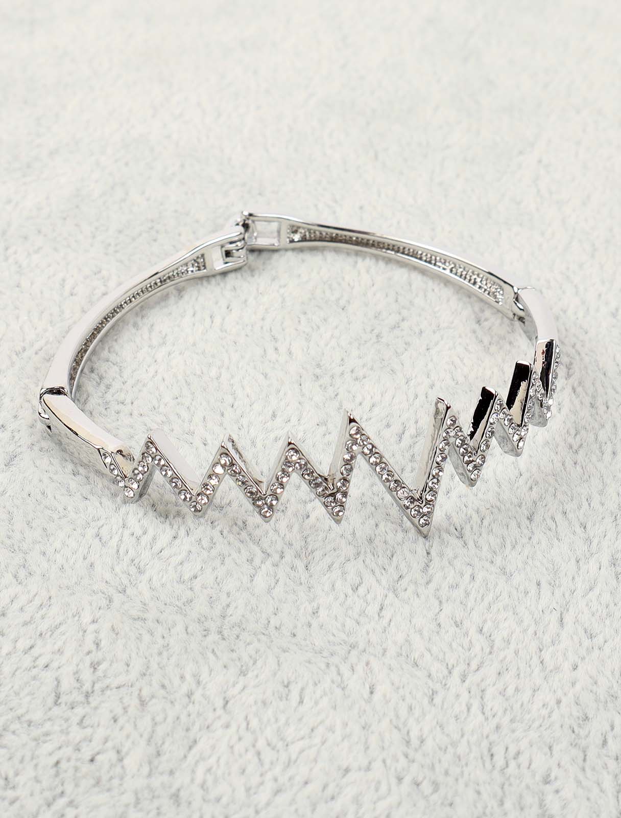 A bracelet in the form of a zigzag decorated with crystals