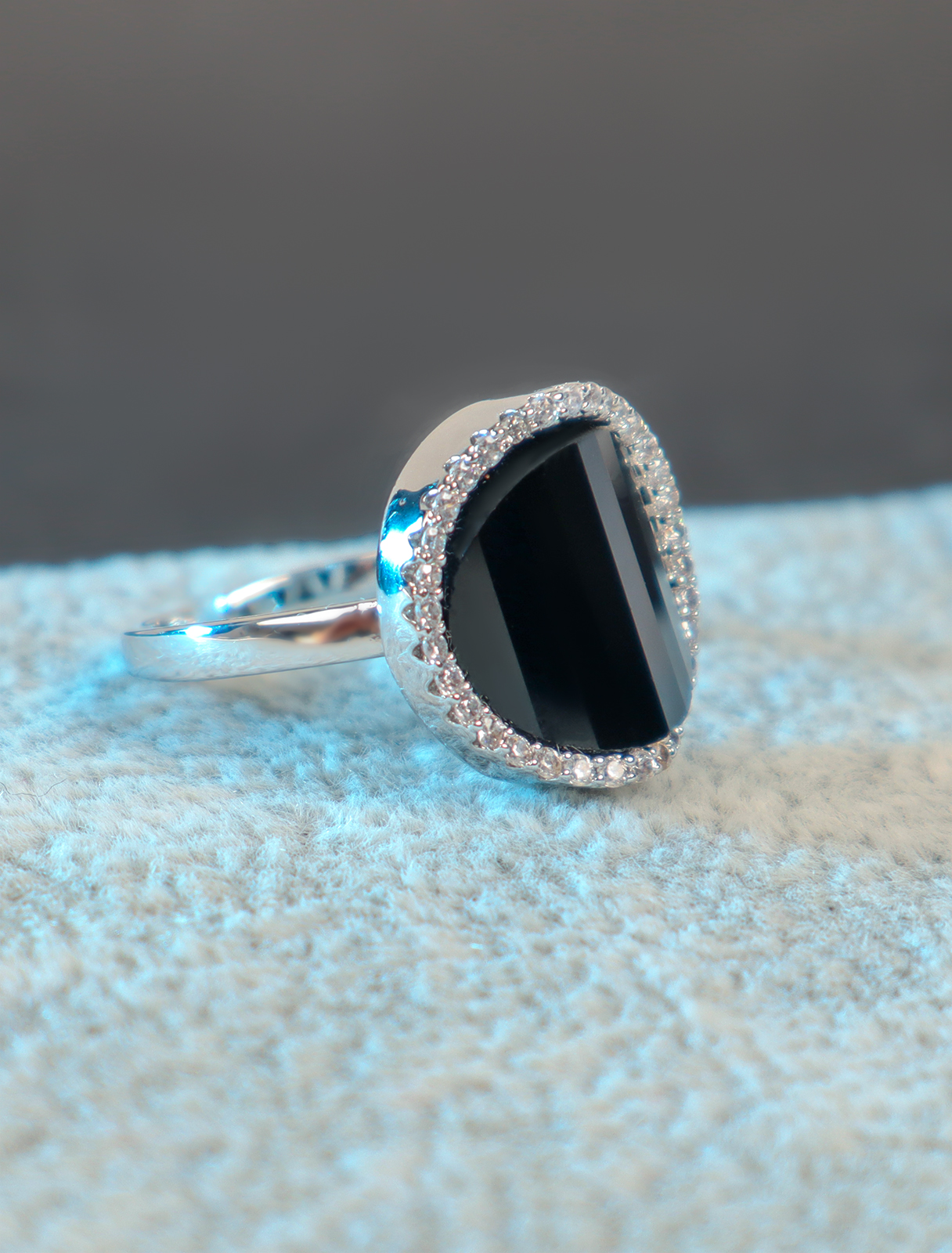 A modern ring with a black stone decorated with crystals