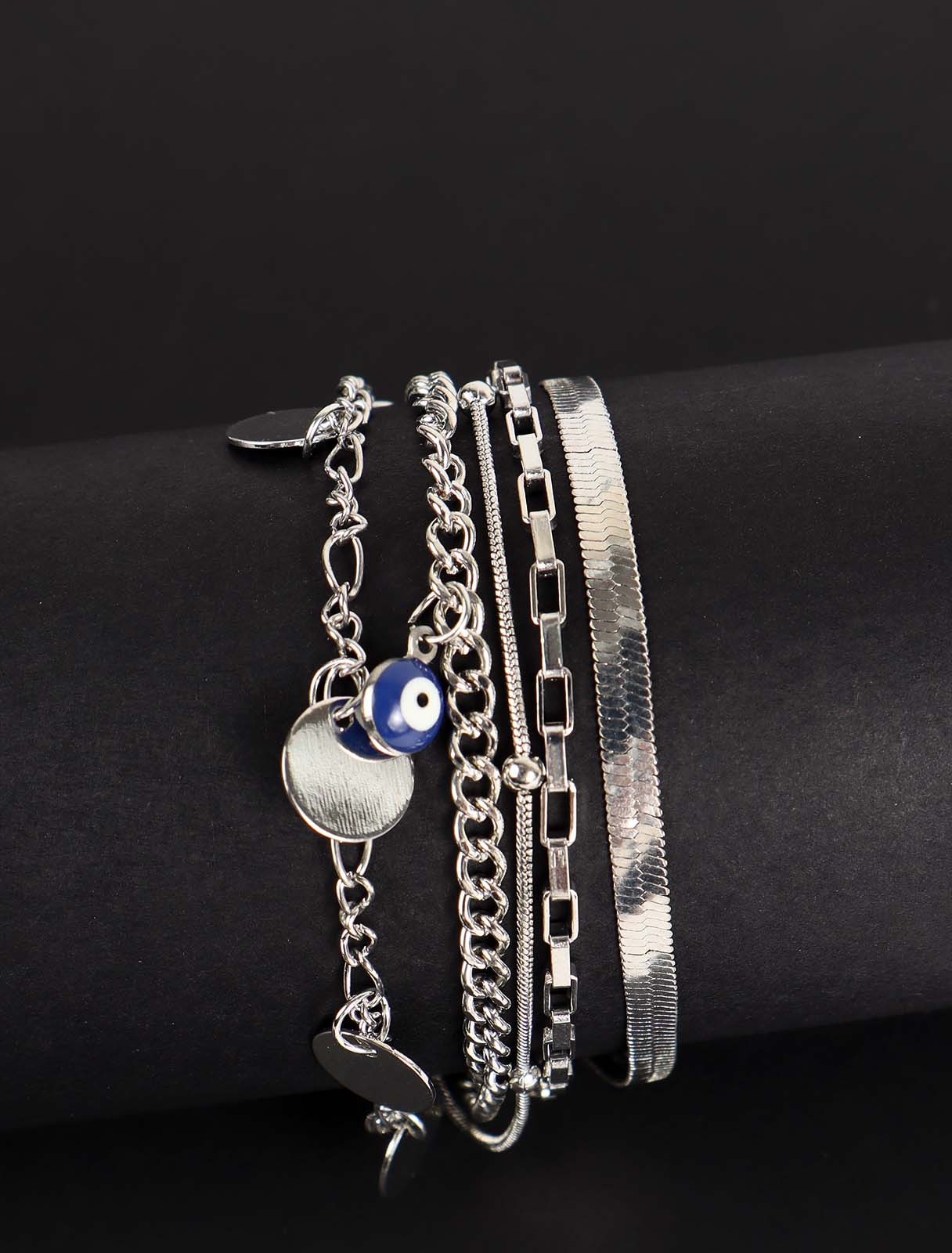 Layered bracelet with circles and eyes pendant