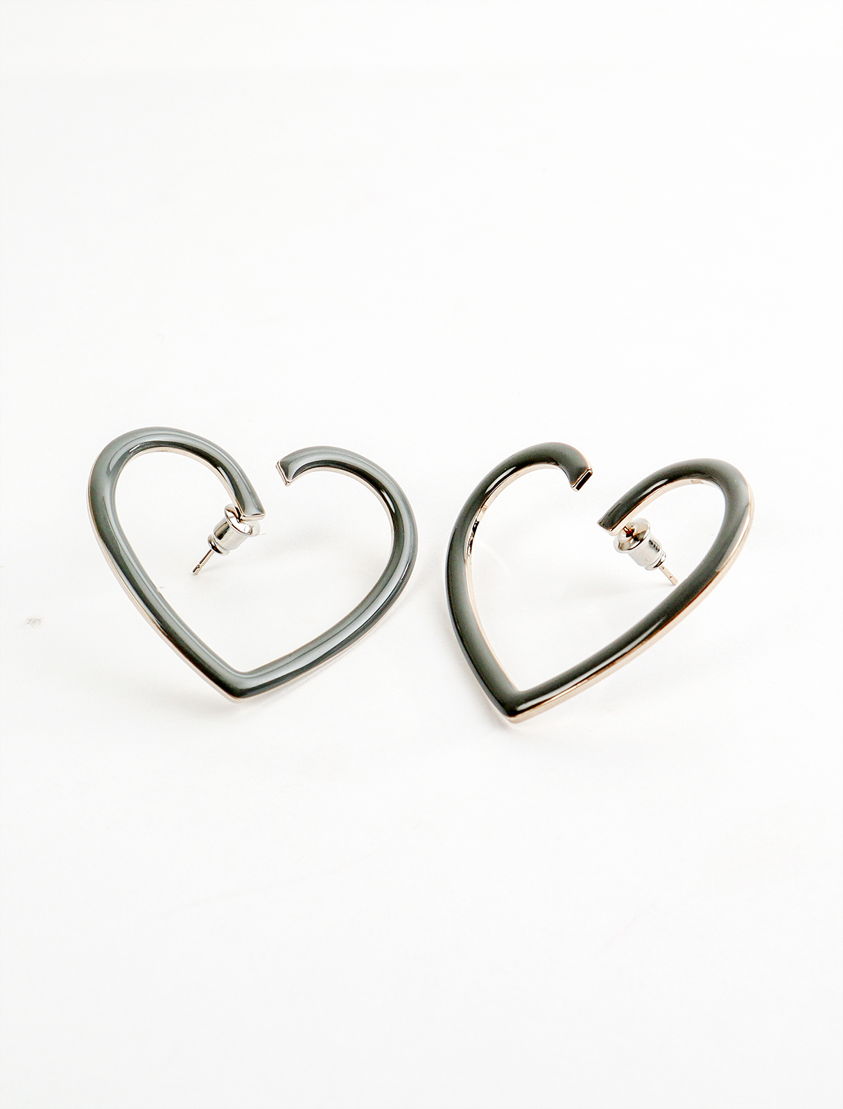 Earrings with a large gray heart design